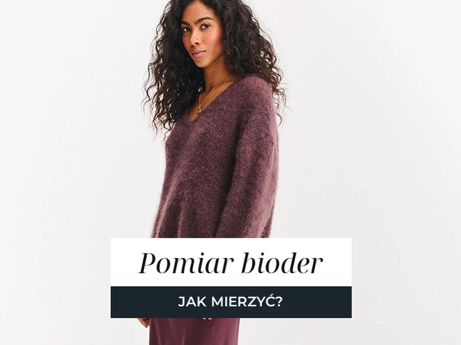 Kobieta w satynowej spódnicy midi, widoczna linia bioder i układ tkaniny.